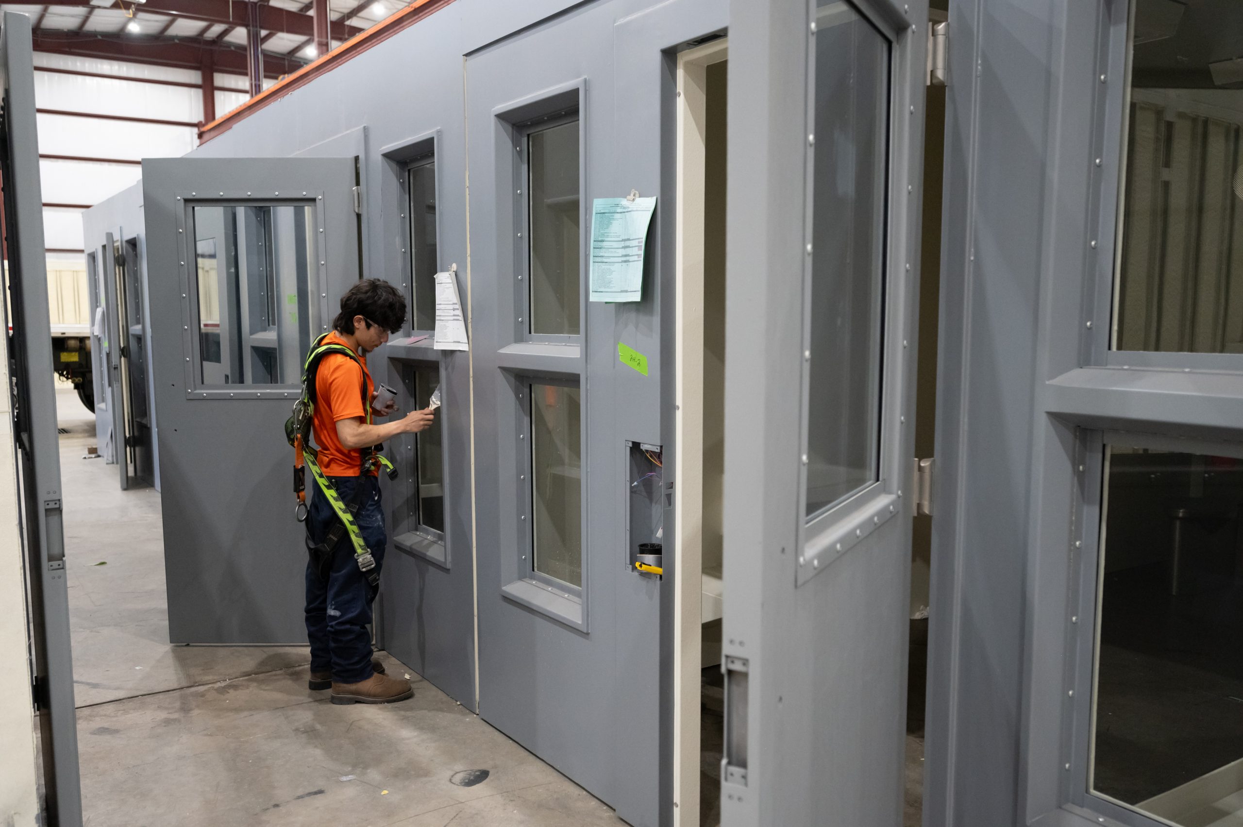 picture of a technician installing a jail cell hinge for maximum security